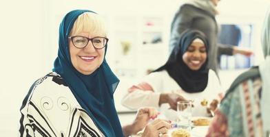 modern muslim grandmother enjoying iftar dinner with family photo