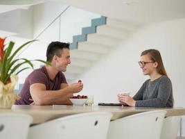 couple enjoying morning coffee and strawberries photo