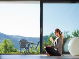 young woman doing morning yoga exercises photo