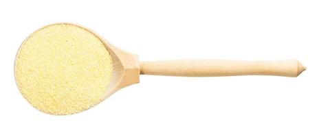 top view of wood spoon with wheat semolina photo