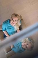 Young woman using laptop at home top view photo