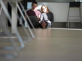 couple using tablet and laptop computers photo