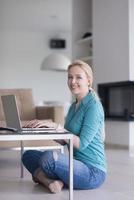 young women using laptop computer on the floor photo