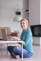 young women using laptop computer on the floor photo