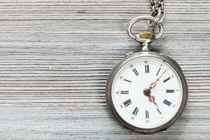 retro pocket watch on gray wooden table photo