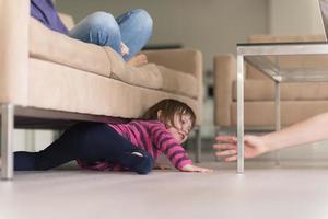 Girl crawling out from the couch photo