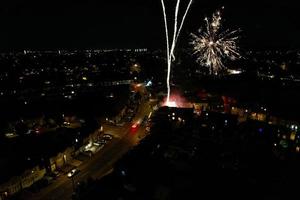 Beautiful Aerial view of British Town at Night and Live Fireworks on Asians Wedding photo