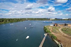Beautiful Aerial Drone's Camera  Footage of Willen Lake and Park which is located at Milton Keynes, England. People are Enjoying at Lake on a Hot Sunny Day of Summer photo