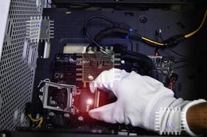 imagen de un técnico insertando un chip de CPU en la placa base de una computadora. foto