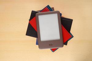 e-book reader on pile of books photo