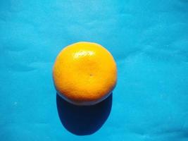 orange on a blue background.high angle view.cold tone photo