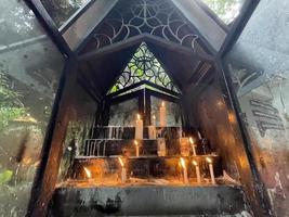Klaten, Central Java, Indonesia, 2022, Bunch of prayers candle flames glowing in the dark create a spiritual atmosphere photo