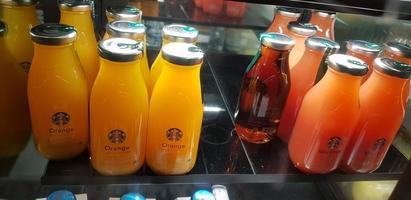 Surakarta, Central Java, Indonesia, 02 August 2022, Starbucks Orange Juice, mix fruit juice and apple juice inside the display fridge photo