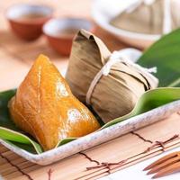Zongzi - Alkaline rice dumpling - Traditional sweet Chinese crystal food on a plate to eat for Dragon Boat Duanwu Festival celebration concept, close up.