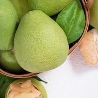 Fresh pomelo, pummelo, grapefruit, shaddock on white background, fruit for Mid-autumn festival, top view, flat lay. photo