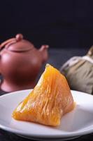 Alkaline rice dumpling zongzi - Traditional sweet Chinese crystal food on a plate to eat for Dragon Boat Duanwu Festival celebration concept, close up. photo