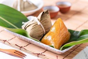 Zongzi - alkaline Chinese rice dumpling crystal food on a plate to eat for traditional Dragon Boat Duanwu Festival concept, close up.