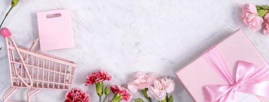 Mother's Day, Valentine's Day background design concept, beautiful pink, red carnation flower bouquet on marble table, top view, flat lay, copy space. photo
