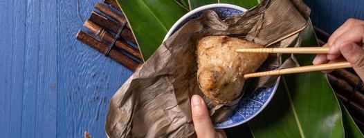 zongzi - Dragon Boat Festival concept Rice dumpling, traditional Chinese food on blue wooden background for Duanwu Festival, top view, flat lay design concept. photo