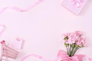 Mother's Day, Valentine's Day background design concept, beautiful pink carnation flower bouquet on pastel pink table, top view, flat lay, copy space. photo