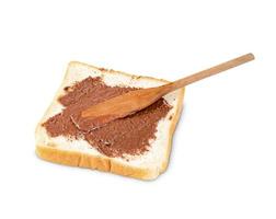 Toasted slice bread with chocolate spread and wooden spatula isolated on white background photo