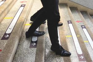 businessman legs walking down the stairs photo