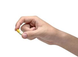 Hand holding capsule pill isolated on white background ,include clipping path photo