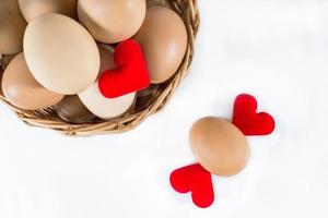 red heart-shaped with egg in basket photo