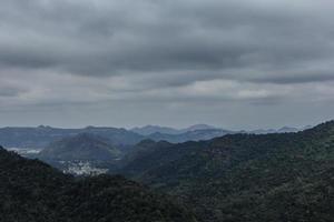 mountain peak landscape with clouds and rain. photo