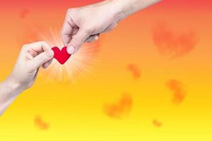 hand holding heart-shaped on background photo