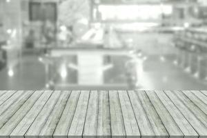 Empty wooden board space platform with blur restaurant background photo