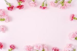 Mother's Day, Valentine's Day background design concept, beautiful pink, red carnation flower bouquet on pink table, top view, flat lay, copy space. photo