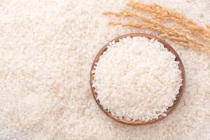 Raw rice in a bowl and full frame in the white background table, top view overhead shot, close up photo