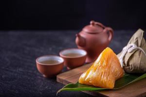 Alkaline rice dumpling zongzi - Traditional sweet Chinese crystal food on a plate to eat for Dragon Boat Duanwu Festival celebration concept, close up. photo