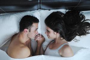 young couple have good time in their bedroom photo