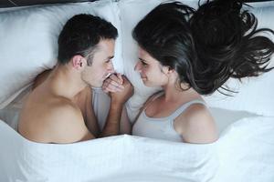 young couple have good time in their bedroom photo