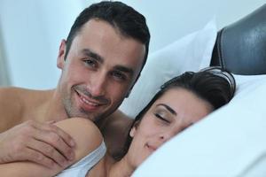 young couple have good time in their bedroom photo