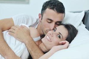 young couple have good time in their bedroom photo