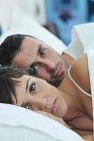 young couple have good time in their bedroom photo