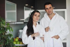 Young love couple taking fresh morning cup of coffee photo