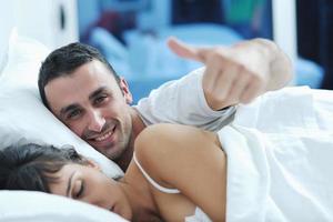 young couple have good time in their bedroom photo