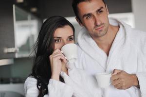 Young love couple taking fresh morning cup of coffee photo