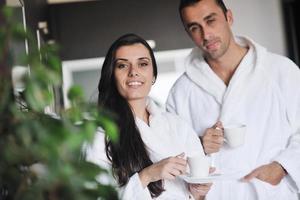 Young love couple taking fresh morning cup of coffee photo