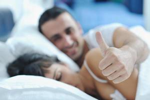 young couple have good time in their bedroom photo