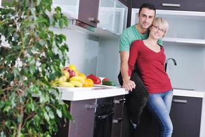 young couple have fun in modern kitchen photo