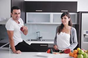 young couple have fun in modern kitchen photo