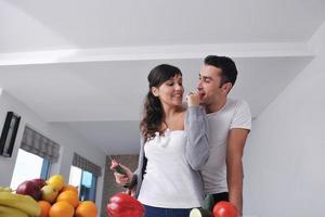 young couple have fun in modern kitchen photo