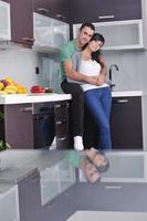 young couple have fun in modern kitchen photo