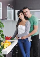 young couple have fun in modern kitchen photo