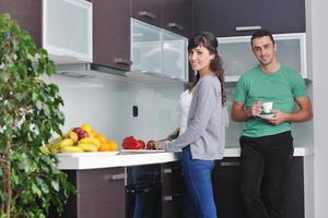 young couple have fun in modern kitchen photo